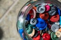 Assortment random colored loose buttons in a glass jar
