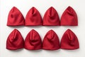 Assortment of Red Santa Claus Christmas Hats Caps on White Background for Festive Holiday Decoration