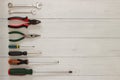 Assortment of repair and construction tools on wood texture background. Wrenches, screwdrivers and pliers on white background with