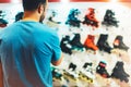 Assortment roller skates isolated in store shop, person choosing and buy color roller-skates on backgraund sun flare, healthy and Royalty Free Stock Photo
