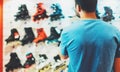 Assortment roller skates isolated in store shop, person choosing and buy color roller-skates on backgraund sun flare Royalty Free Stock Photo