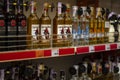 Assortment of rum and tequila on a supermarket shelf with price tags