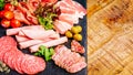 Assortment of salami prosciutto meats and sausages, olives and spices.Meat appetizer.Different types of sausages with Royalty Free Stock Photo