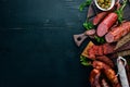 Assortment of salami and snacks. Sausage Fouet, sausages, salami, paperoni. On a black wooden background. Royalty Free Stock Photo