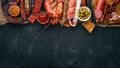 Assortment of salami and snacks. Sausage Fouet, sausages, salami, paperoni. On a stone background. Royalty Free Stock Photo