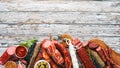 Assortment of salami and snacks. Sausage Fouet, sausages, salami, paperoni. On a white wooden background. Royalty Free Stock Photo