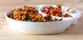 Assortment salty crunchy indian mix Nimco or Namkeen and spicy coated peanut white bowl wooden background