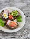 Assortment of sandwiches - sandwiches with cheese, radish, cucumber, quail egg, avocado and smoked salmon. Royalty Free Stock Photo