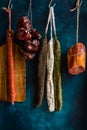 Assortment of sausages, Spanish charcuterie, wood cutting board, string with dry peppers