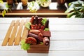 Assortment of sausages in wooden box copyspace