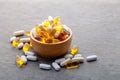 Assortment scattered pharmaceutical medicine tablets, pills, drugs in wooden bowl on gray background. White food dietary Royalty Free Stock Photo