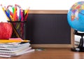 Assortment of School Suppies with Blank Chalkboard