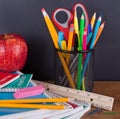 Assortment of School Suppies with Chalkboard Background