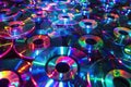 Assortment of shiny compact discs reflecting a spectrum of colors in a pattern, symbolizing data storage Royalty Free Stock Photo