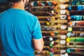 Assortment skateboard isolated in store shop, person choosing and buy color skates on backgraund sun flare, healthy and activity l Royalty Free Stock Photo