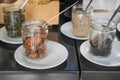 Assortment of small topping jars arranged on plates for sampling Royalty Free Stock Photo