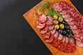 Assortment smoked sausage slices on cutting board