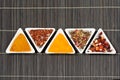 Assortment of spices over a bamboo mat Royalty Free Stock Photo