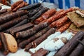 Assortment of spicy dried or smoked beef and pork salami, sausages, chorizo. Various kind types of salami and sausages in market, Royalty Free Stock Photo