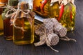 Assortment of spicy oils with herbs and spices in different bottles