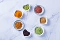 Assortment of superfood powder, acai, turmeric, ginger, matcha, cinnamon, wheat