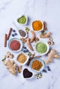 Assortment of superfood powder, acai, turmeric, ginger, matcha, cinnamon, wheat