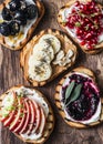 Assortment sweet sandwiches with cream cheese and apple, pomegranate, jam, grapes, peanut butter, banana, flax seed, chia, nuts on Royalty Free Stock Photo