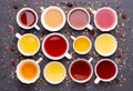 Assortment of tea cups on dark, stone background