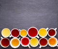 Assortment of tea cups on dark, stone background