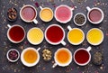 Assortment of tea cups on dark, stone background