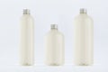 Assortment of three plastic tall, low and thick bottles with pale fresh drink or cosmetic essential oil, silver cap mockup.