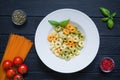 Assortment of tortellini, red tomato, green with spinach and che