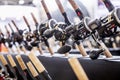 an assortment of trolling fishing reels on the counter of a fishing store