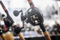 an assortment of trolling fishing reels on the counter of a fishing store