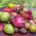 Assortment of tropical fruits - green mango, avocado, rambutan, dragon fruit, salak, sapodilla and orange in island Bali, Indonesi