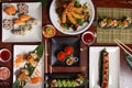 Assortment of typical Japanese dishes served at the restaurant table. Sushi, niguiri, tempura, maki