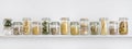 Assortment of uncooked groceries in glass jars arranged on shelf