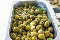 Assortment variety of handmade artisan marinated brine cured antipasti tapas green olives with herbs and cheese in oil