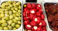 Assortment variety of handmade artisan marinated brine cured antipasti tapas green olives with herbs sun dried and stuffed tomato