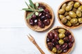 Assortment from various olives in wooden bowls top view.
