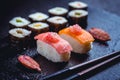 Assortment of vegan sushi with vegetables, seitan, Konjac plant, tofu as fish substitudes, with finger lime as caviar on black