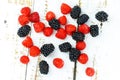 Assortmentof fresh berries. Raspberry and gooseberry on wooden surface. Fresh snack during summer time. Perfect image for school Royalty Free Stock Photo