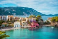 Assos village. Beautiful view to vivid colorful houses near blue turquoise colored transparent bay lagoon. Kefalonia