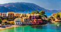 Assos village in Kefalonia, Greece. Turquoise colored bay in Mediterranean sea with beautiful colorful houses in Assos village in