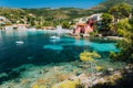 Assos village, Kefalonia Greece. View to cute bay with vivid colored houses and transparent turquoise water surrounded