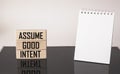 Assume good intent . Inspirational quote on wooden blocks