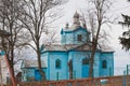 Assumption of the Mother of God russian Orthodox church, wooden temple built on a hill, bare winter trees Royalty Free Stock Photo