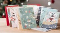 A stack of Christmascards each with a different festiv one generative AI Royalty Free Stock Photo