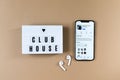 Astana, Kazaakhstan - February, 17, 2021: Clubhouse application on iphone, headphones airpods