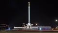 Stele monument Kazakh Eli with bird Samruk and Palace of Independence timelapse hyperlapse at night. Royalty Free Stock Photo